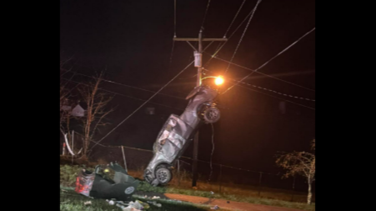 Deputies were summoned to a single-vehicle crash and arrived to find a Ford F-150 hanging by its tailgate and a trail of destruction, West Virginia officials said. The driver survived.