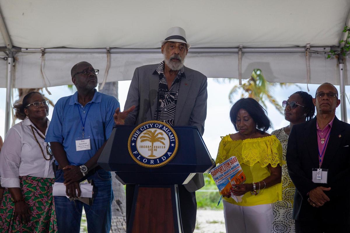 Gene Tinnie, center, chairman of Virginia Key Beach Park Trust, speaks during a ceremony at Historic Virginia Key Beach Park Monday.
