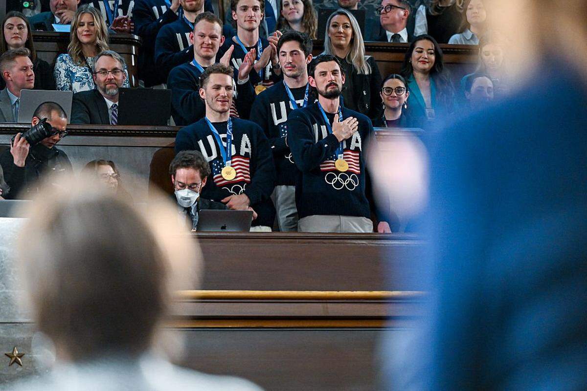 WASHINGTON, DC - FEBRUARY 24: The U.S. men's Olympic ice hockey team with Matthew Tkachuk and Connor Hellebuyck in front attend President Donald Trump's State of the Union address to a joint session of Congress in the House Chamber at the Capitol on February 24, 2026 in Washington, DC. Behind him are Vice President JD Vance and House Speaker Mike Johnson (R-LA). Trump delivered his address days after the Supreme Court struck down the administration's tariff strategy, and amid a U.S. military buildup in the Persian Gulf threatening Iran. (Photo by Kenny Holston-Pool/Getty Images)