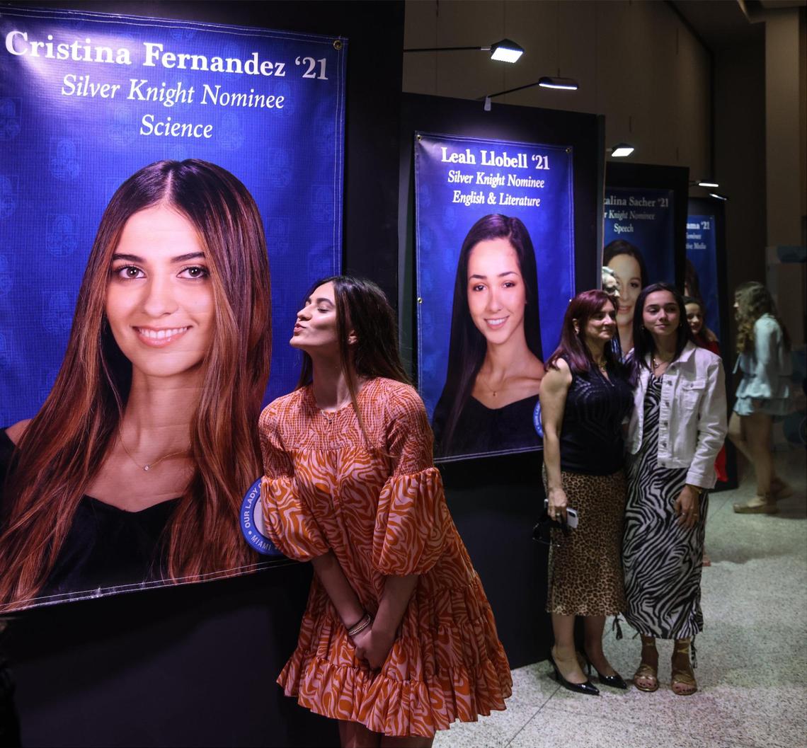 Cristina Fernandez, 18, senior, blows a kiss to the large photo of herself that is displayed among other Our Lady of Lourdes Academy Silver Knight Awards nominees upon her parents request for a quick photo. Our Lady of Lourdes Academy hosted a Silver Knight Awards watch party where Brooke Merdjane received an Honorable Mention for Mathematics on Thursday, May 20, 2021.