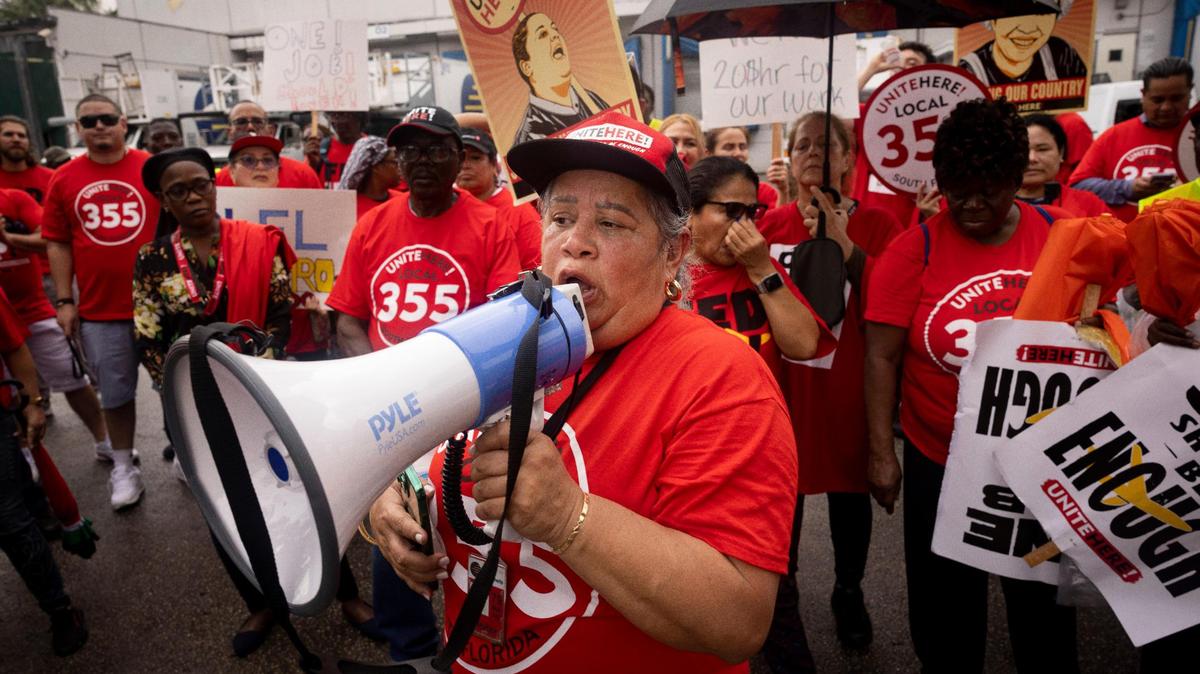 Maria Sanchez, who has worked at LSG Sky Chefs for 10 years, uses a megaphone Wednesday to participate in the labor protest on Wednesday, Oct. 11, 2023.