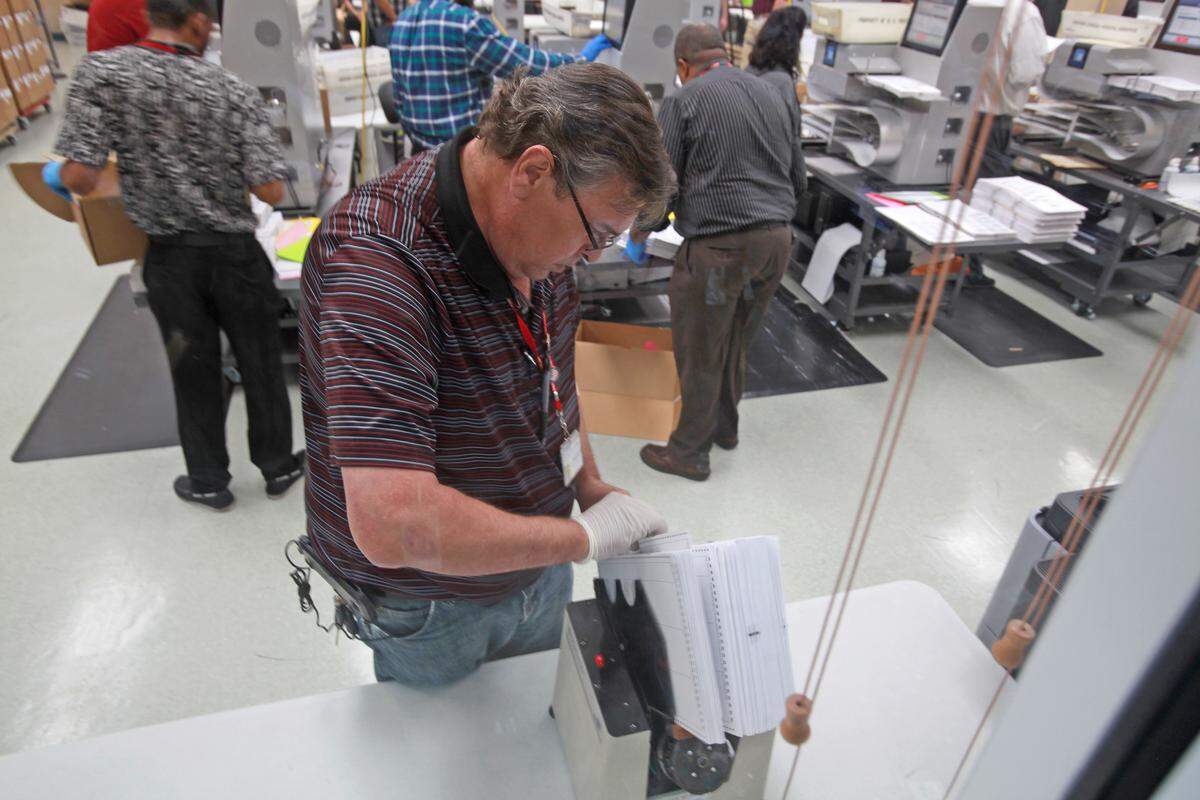 Election workers recount votes from the midterm election on Tuesday, Nov. 13, 2018, at the Broward Supervisor of Elections Office in Lauderhill, Florida.