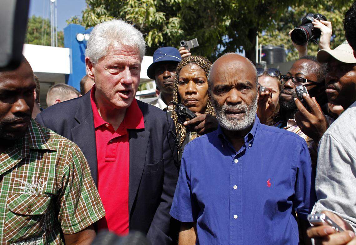 In this file photo, U.N. special envoy for Haiti and former U.S. President Bill Clinton, second from left, speaks with Haiti’s President René Préval, right, after arriving in Port-au-Prince on Feb. 5, 2010. Clinton expanded his U.N. role as head of relief and reconstruction efforts after the Jan. 12 earthquake.