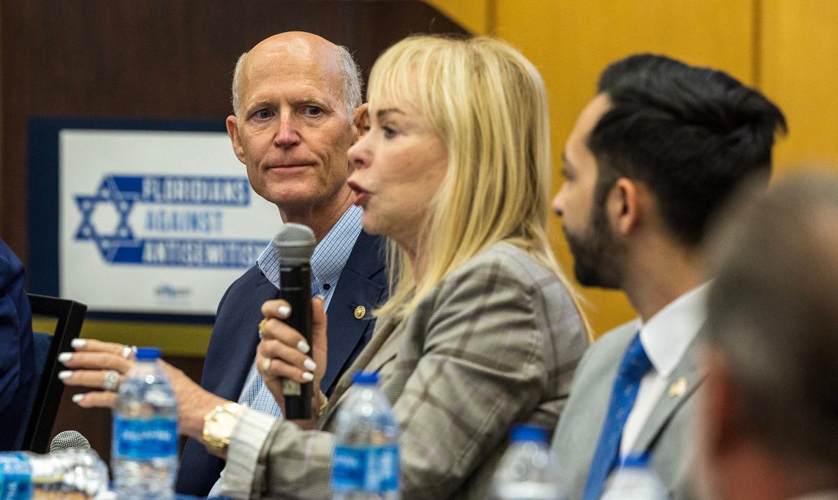 Senator Rick Scott listens as Barbara Feingold speaks during the Floridians Against Anti-Semitism roundtable event at Florida International University, in Miami, on Friday September 20, 2024.