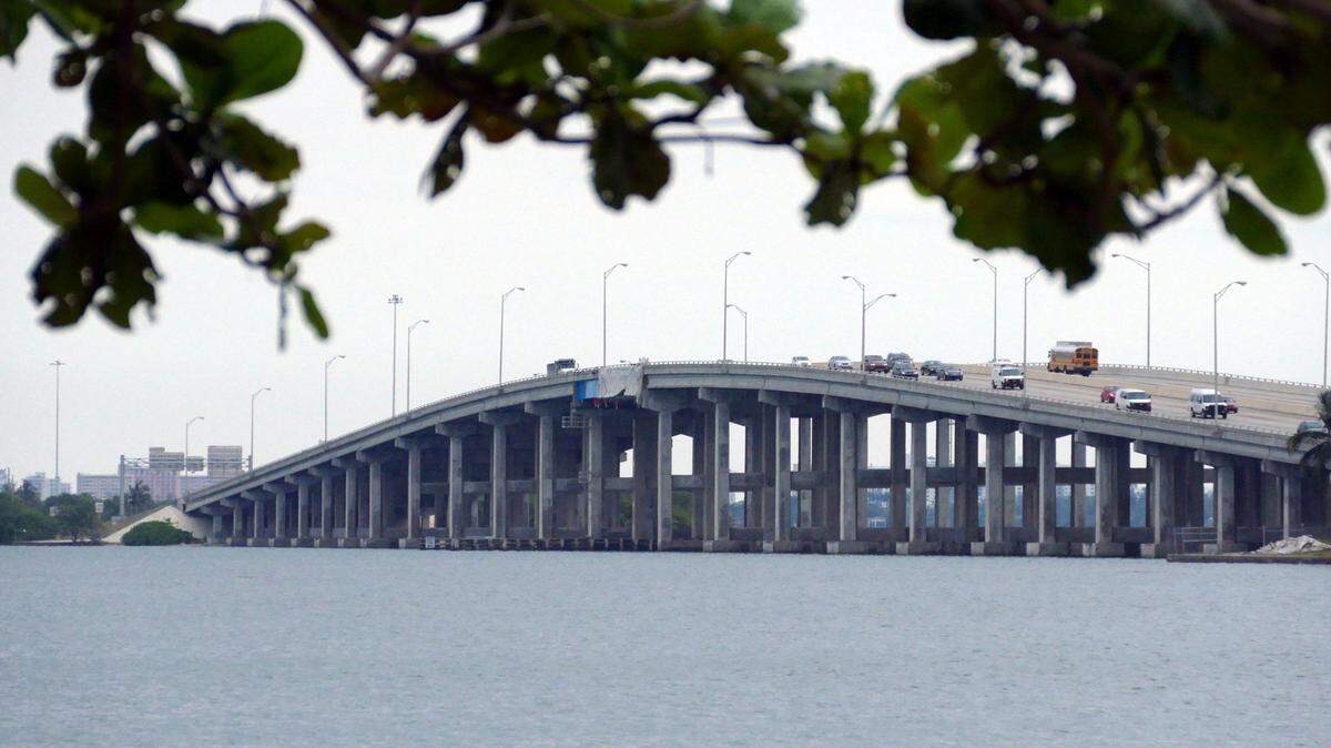 A car hit an electric bike early Tuesday morning, Aug. 19, 2025, on the Julia Tuttle Causeway in Miami Beach. One cyclist died and another is in critical condition, authorities said.