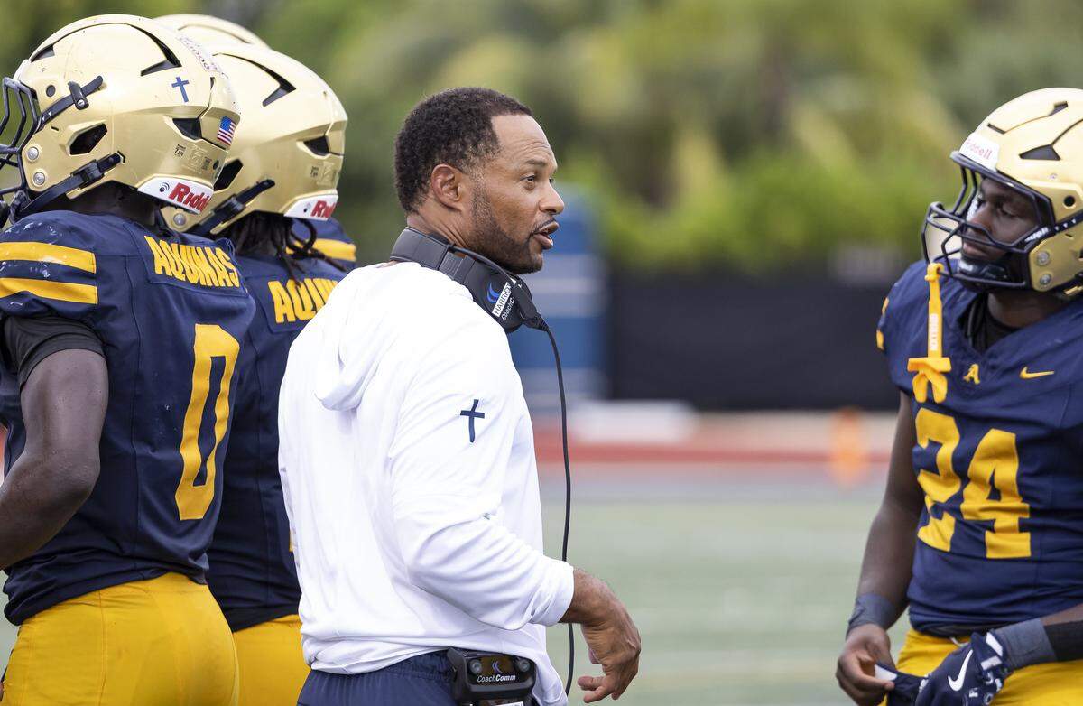 St. Thomas Aquinas Raiders head coach Roger Harriott talks to his team as they play against the Mater Dei Monarchs in the first half of their football game at St.Thomas Aquinas High School on Saturday, Aug. 23, 2025, in Fort Lauderdale, Fla.