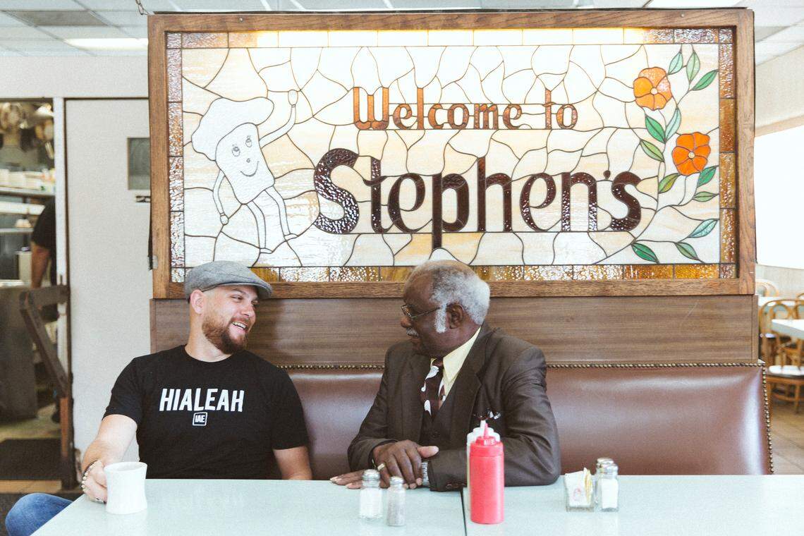 Matt Kuscher, left, bought Stephen’s Delicatessen in November 2017 and kept its longest-running employee, Henderson “Junior” Biggers, who learned to hand-carve the pastrami and corned beef made in house in his 62 years at Stephen’s.