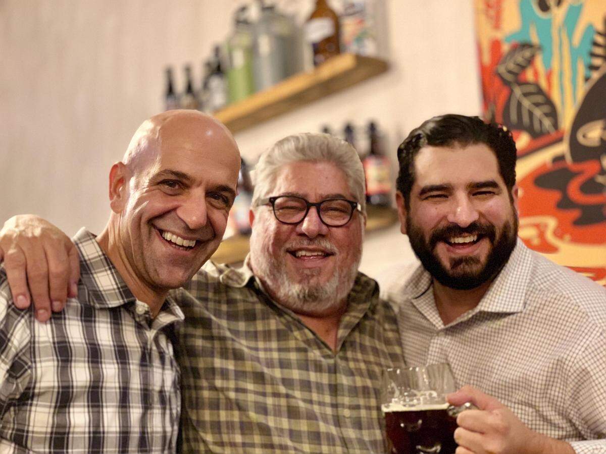 Craft Brew Alliance’s CEO Andy Thomas (left to right) with Luis and Luis G. Brignoni, who sold their Wywnood Brewing Company to CBA Oct. 10. Terms of the sale were not disclosed.