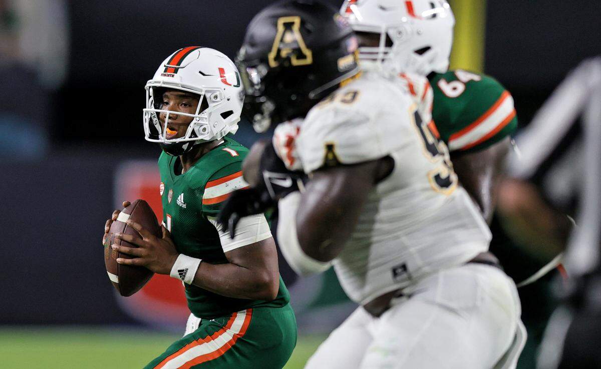 Miami Hurricanes quarterback D’Eriq King (1) sets up to pass as Hurricanes offensive lineman Jalen Rivers (64) blocks Appalachian State Mountaineers defensive lineman KaRon White (93) during the third quarter of their ACC football game at Hard Rock Stadium on Saturday, September 11, 2021 in Miami Gardens, Florida.