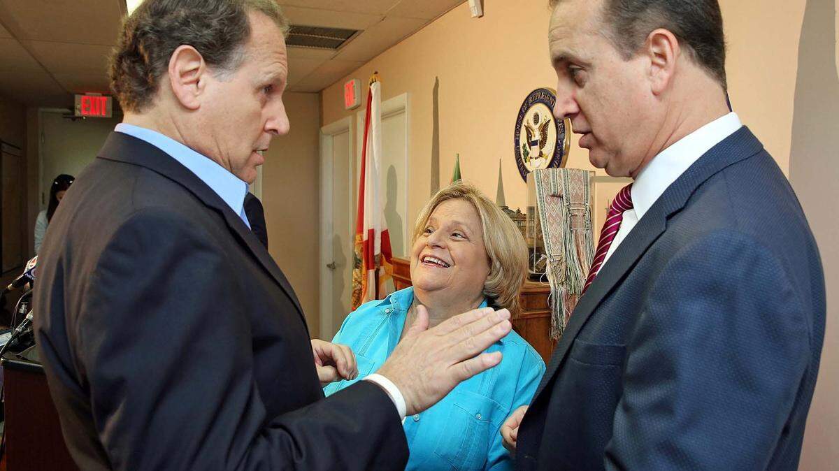 Congresswoman Ileana Ros-Lehtinen, middle, speaks with former Congressman Lincoln Diaz-Balart, left, and his brother Congressman Mario Diaz-Balart before a press conference after the death of Cuban dictator Fidel Castro on Saturday November 26, 2016.