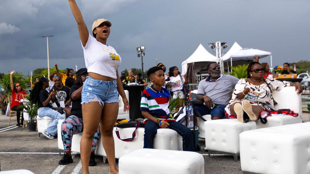 Aiyana C. Edwards, 21, left, and her brother Christopher, 10, right, react to the live musical performance from the VIP section during the 3rd Annual Juneteenth Park-In and Party Celebration under this year’s theme, “Experience in the Gardens” at Hard Rock Stadium on Saturday, June 17, 2023, in Miami Gardens, Florida.