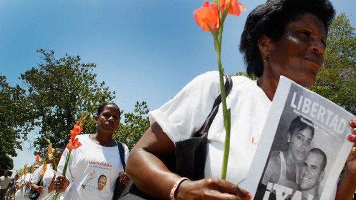 Women in the Cuban dissident group Ladies in White march to demand the release of the regime’s political prisoners.