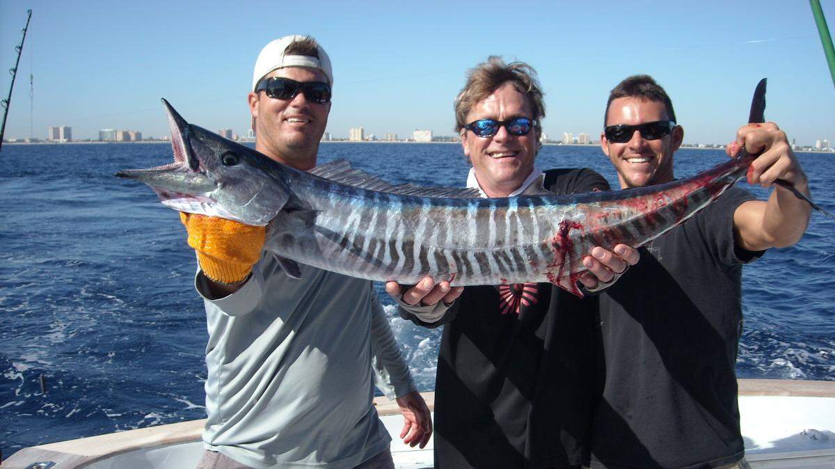  Left to right, Capt. Stan Hunt, Eric Brandon and mate Tom Bardes show off a wahoo that was snagged on a charter  fishing trip.