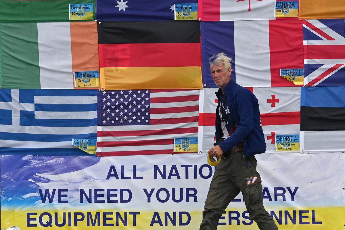 Ryan Wesley Routh walks by a mural showing flags of the countries helping Ukraine in Independence Square in Kyiv on June 23, 2022.