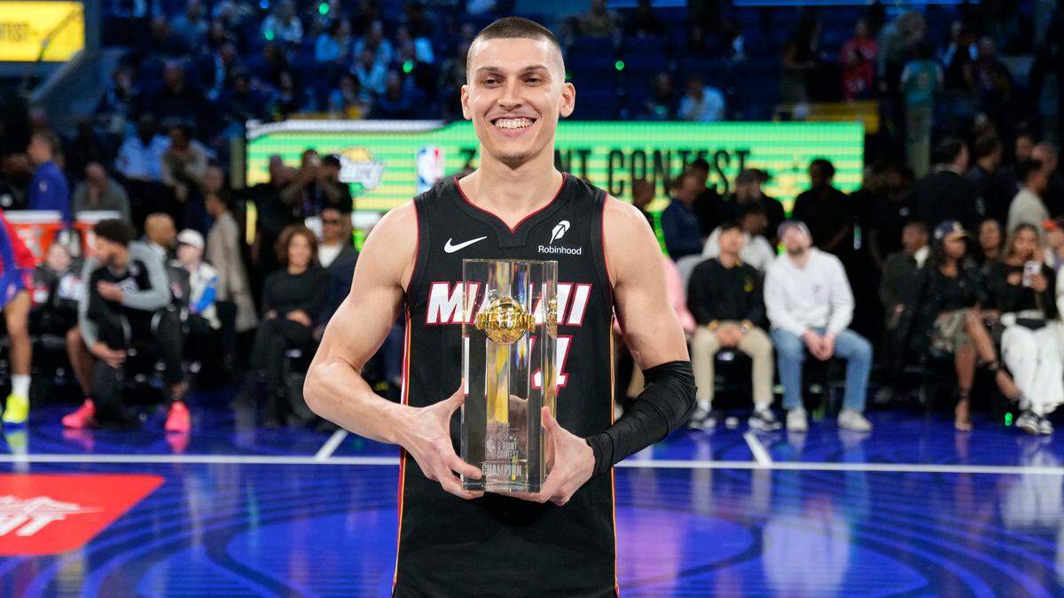 Miami Heat guard Tyler Herro (14) celebrates with the trophy after winning the three-point contest during All Star Saturday Night ahead of the 2025 NBA All Star Game at Chase Center.