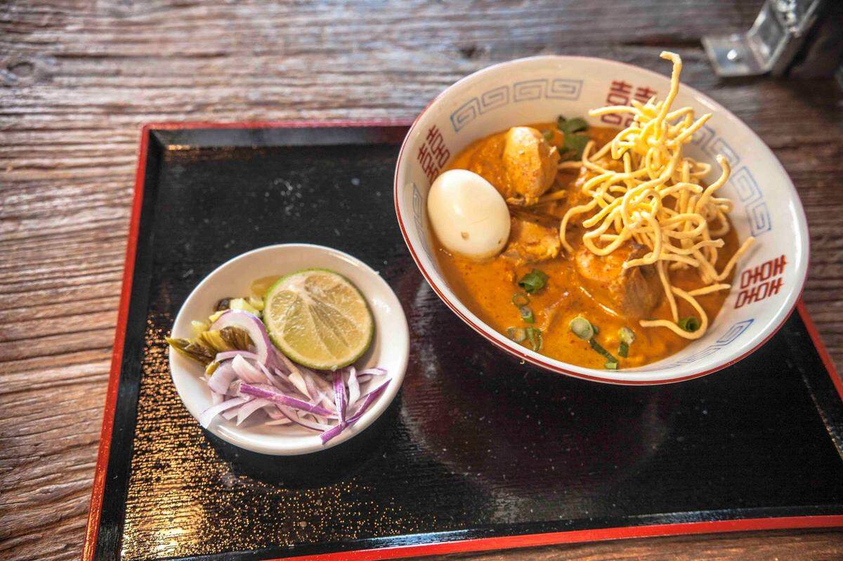 Egg noodles in yellow curry broth at Ohho Noodles Market
