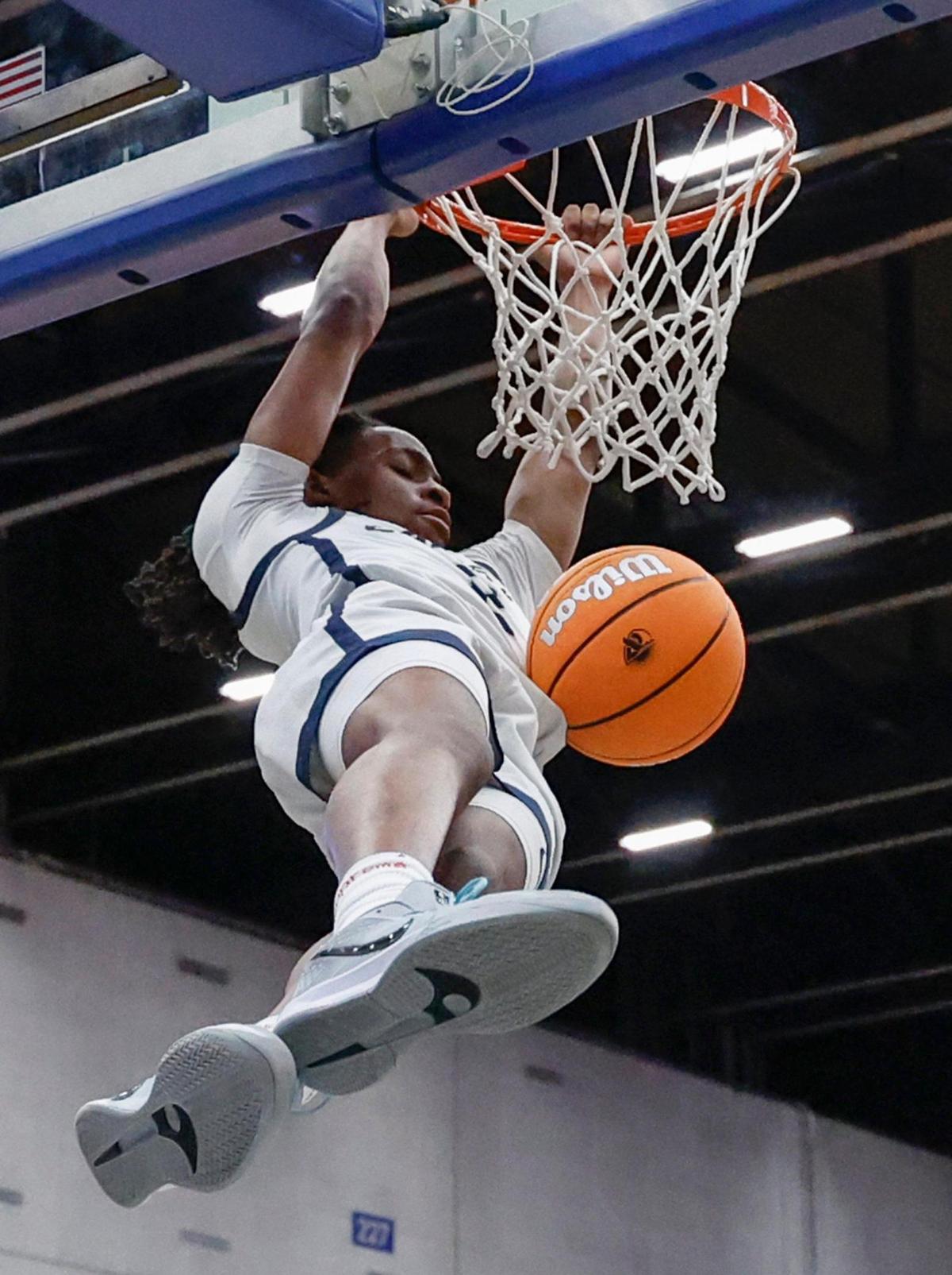 Calvary Christian Academy’s Kenneth Francis, Jr. (2) dunks the ball against Cardinal Gibbons in the first half during boys 3A basketball semifinal game of the Florida High School State Championships at the RP Funding Center in Lakeland, Florida on Friday, February 28, 2025.