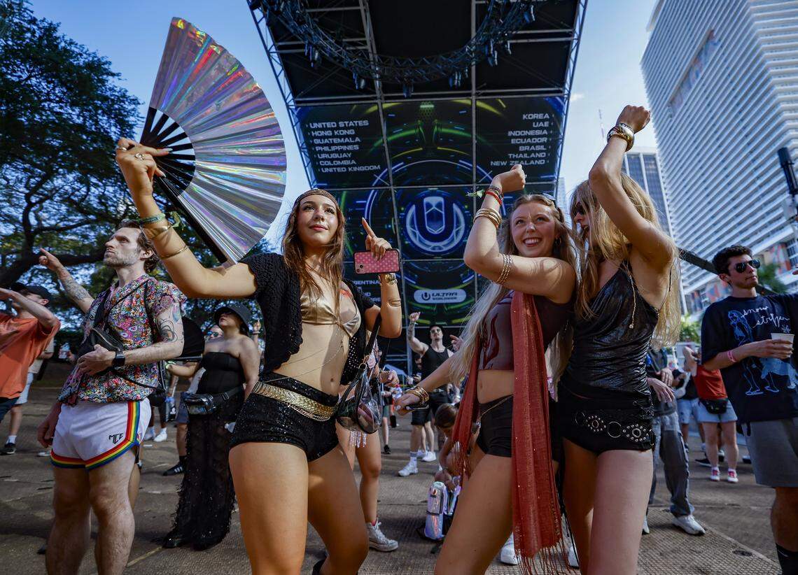 Maya Miknay, Eva Frenchowicz, and Johannan Berryman, seen left to right, dance in front of the World Wide Stage at Ultra Music Festival in Miami, Florida, on Friday, March 27, 2026.
