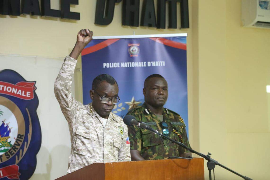 Haitian national police spokesman Michel-Ange Louis Jeune, left, stands with Kenyan Police Commissioner Jack Ombaka, right, to discuss the recent success of a joint large-scale operation that allowed security forced to reclaim control of a key telecom site from gangs. They held a press conference on Tuesday, Aug. 26, 2025.