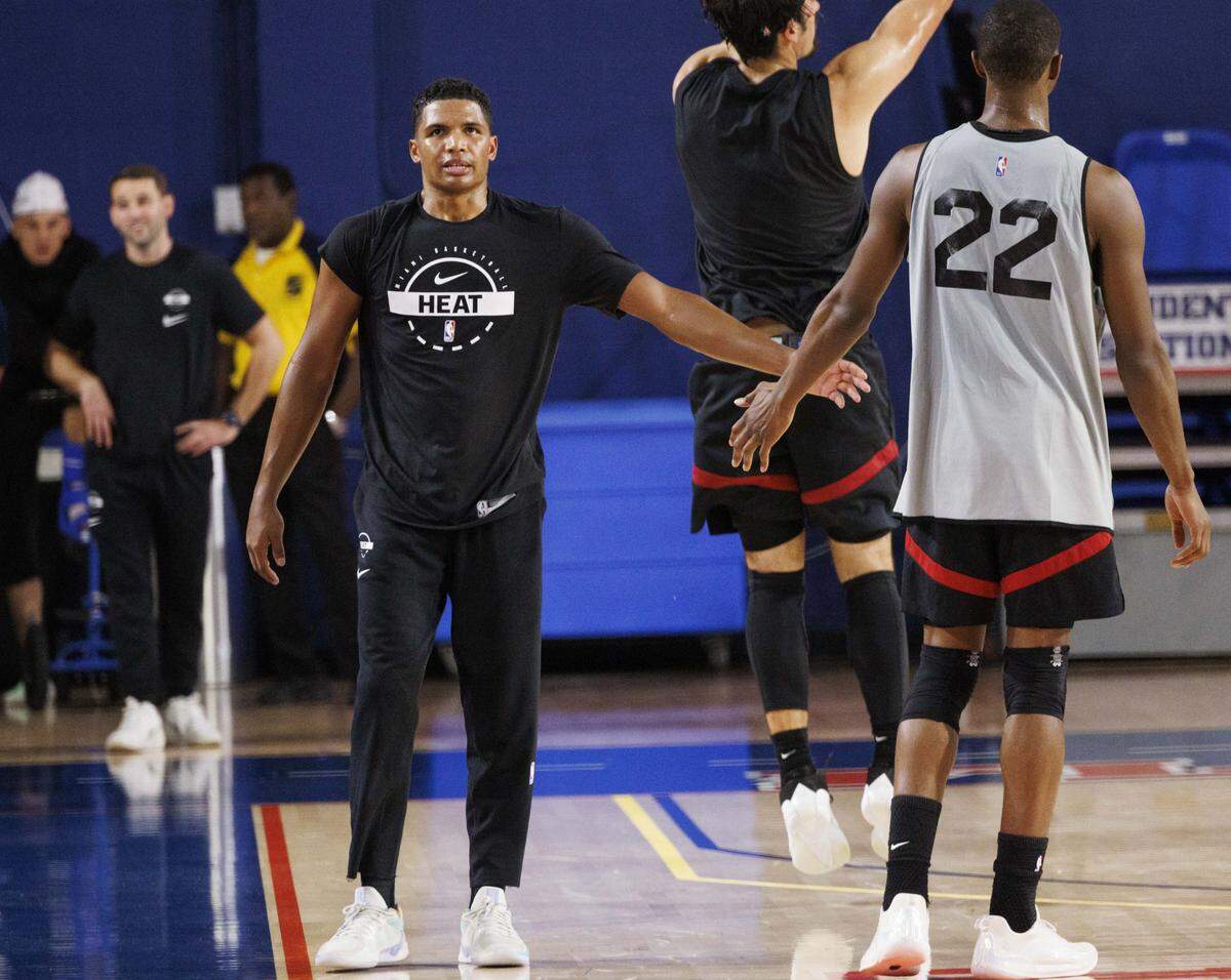 Dru Smith (12) high-fives Andrew Wiggins (22) during the first day of Miami HEAT Training Camp on Sept. 30, 2025, at Florida Atlantic University in Boca Raton.