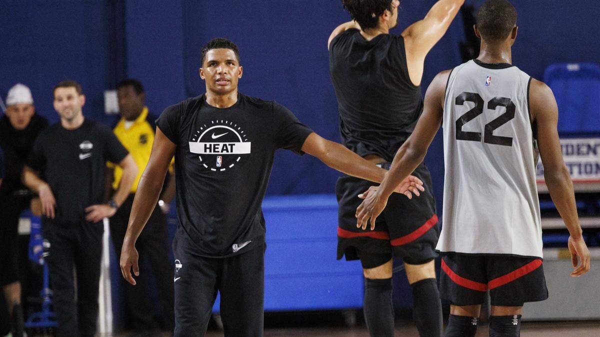 Dru Smith (12) high-fives Andrew Wiggins (22) during the first day of Miami HEAT Training Camp on Sept. 30, 2025, at Florida Atlantic University in Boca Raton.