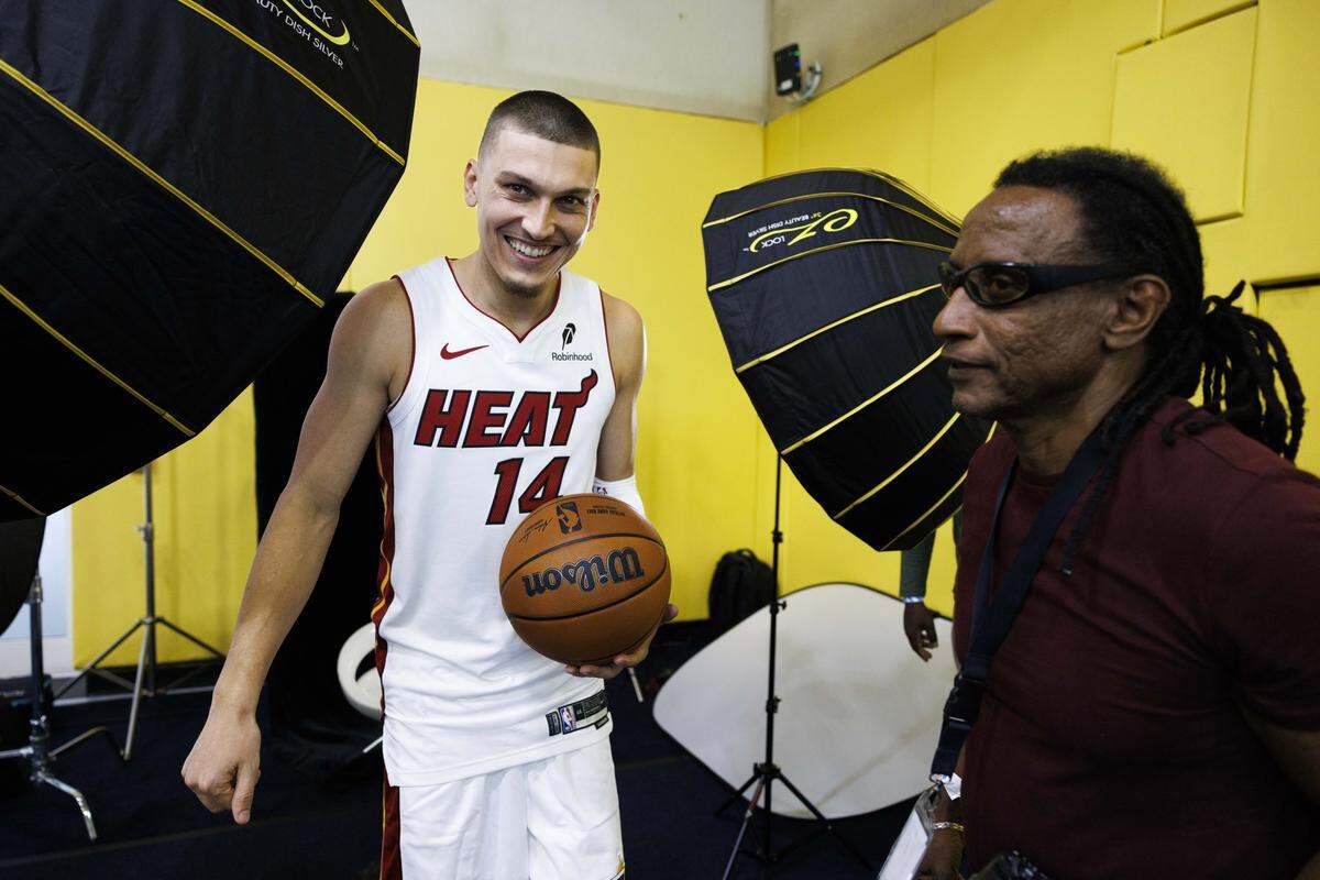 Tyler Herro (14) laughs after a portrait session with Miami Herald photographer Carl Juste, right, during the Miami HEAT Media Day on Monday, Sept. 29, 2025, at the Kaseya Center in downtown Miami, Fla.