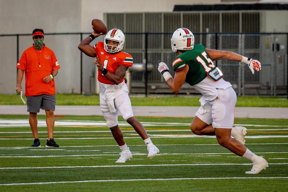 University of Miami quarterback DEriq King (1) attempts a pass as defensive end Jaelan Phillips defends during the Hurricanes second scrimmage on Saturday, August 22, 2020.