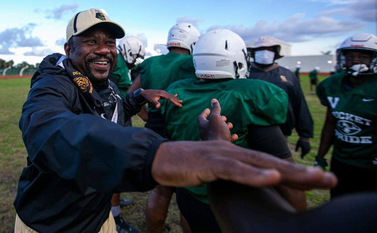 Miami Central head coach Roland Smith runs drills with his team during a preseason practice at his school’s field in Miami’s West Little River neighborhood on Thursday, August 5, 2021.