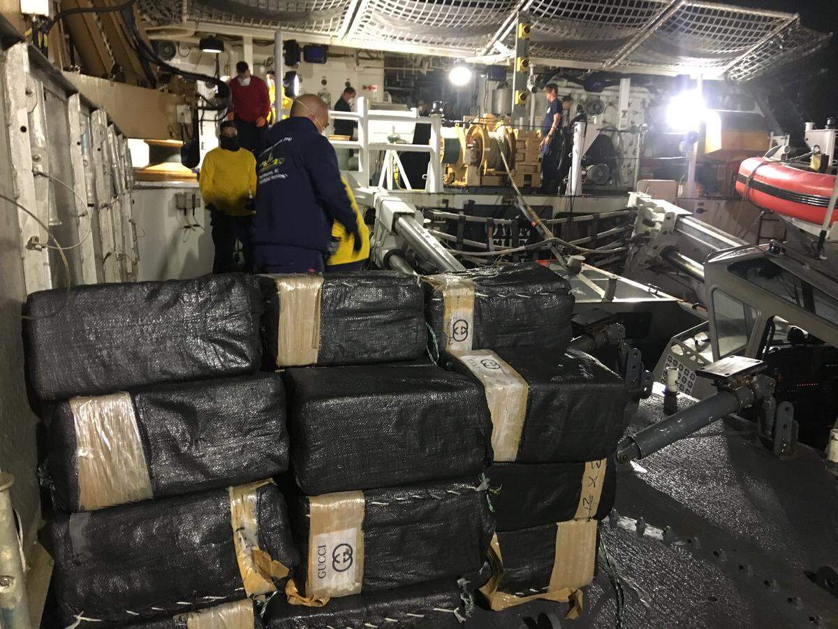 The U.S. Coast Guard sorts out bales and bales of cocaine seized from a ship on the Eastern Pacific. The cocaine cartels frequently leave a logo on their shipments to indicate who it belongs to. This trafficker chose the logo of Gucci. This load, valued at $18 million, was found floating in the middle of the ocean.