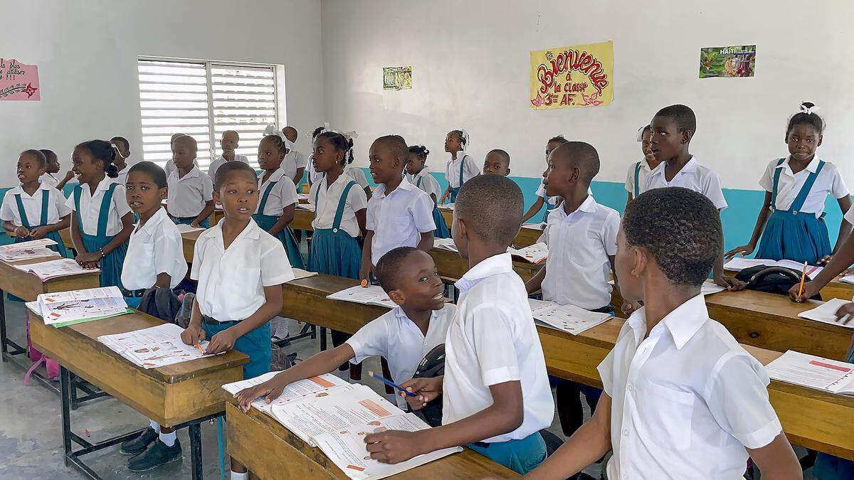 Students at Institution Mixte Notre Dame de l’Assomption in Port-au-Prince, Haiti, shout out early Christmas gift requests during a visit on Thursday, Feb. 16, 2023, by Digicel Group Founder and Chairman Denis O’Brien and his Digicel Foundation team. The school’s operators, the Montfort Missionaries, are requesting help with a new expansion, which O’Brien agreed to.