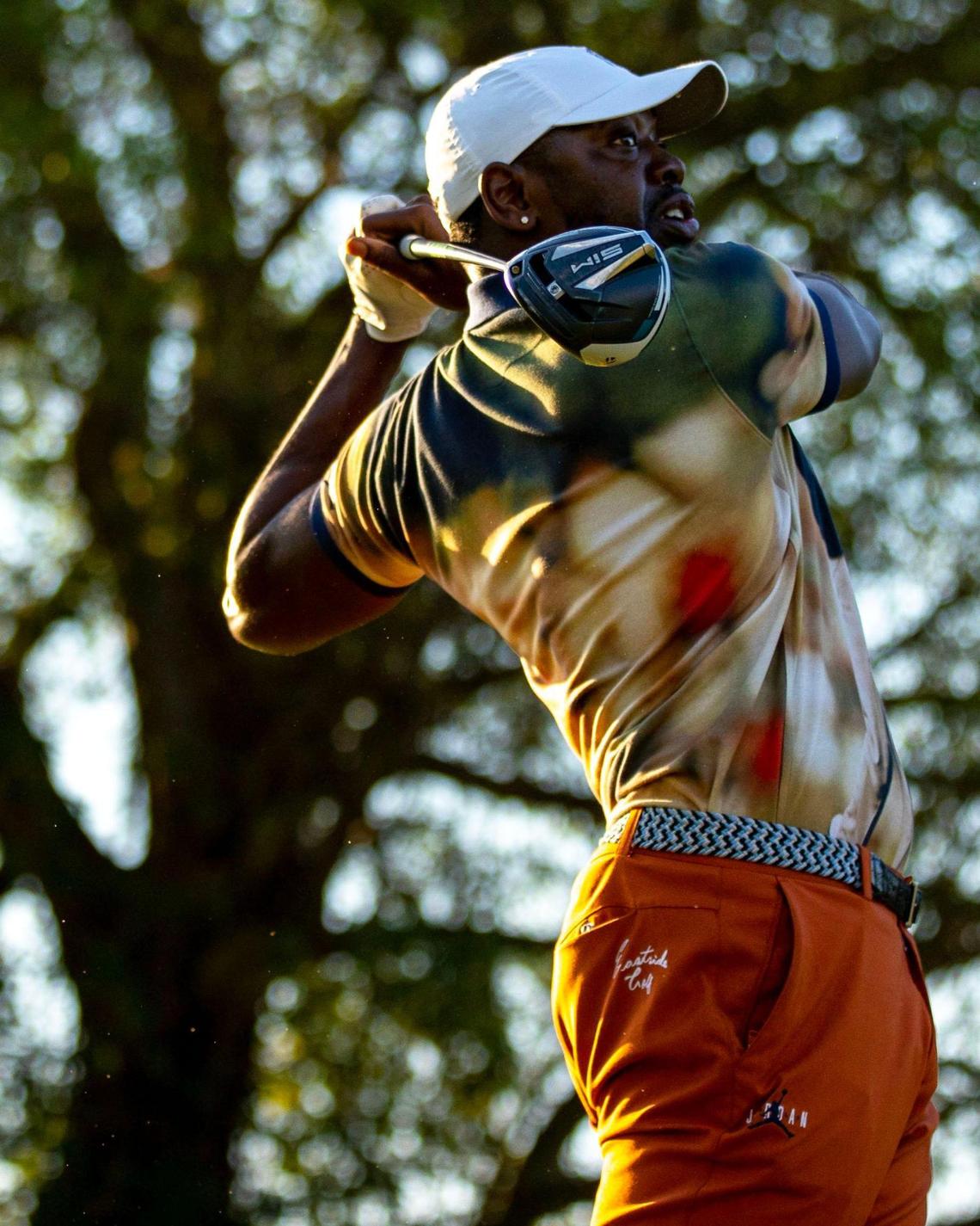 Eastside Golf founder Olajuwon Ajanaku drives from a tee box at Miami Springs Golf & Country Club in Miami Springs, Florida, on Saturday, December 10, 2022. Eastside Golf is a lifestyle golf brand developed to raise awareness about golf among youth and non golfers.
