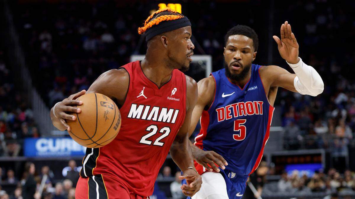 Miami Heat forward Jimmy Butler (22) dribbles as Detroit Pistons guard Malik Beasley (5) defends in the first half at Little Caesars Arena.