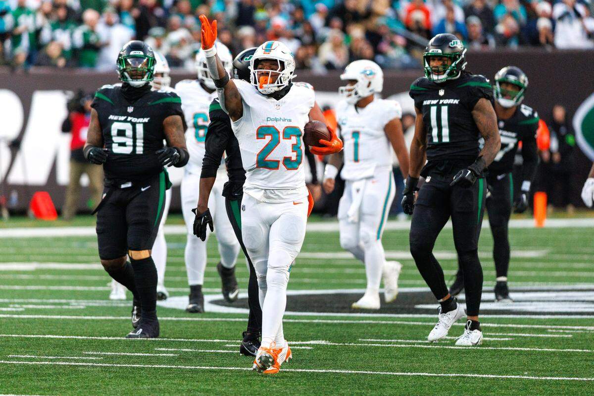 Miami Dolphins running back Jeff Wilson Jr. (23) reacts after running for a first down during second quarter of an NFL football game against the New York Jets at MetLife Stadium on Friday, Nov. 24, 2023 in East Rutherford, New Jersey.