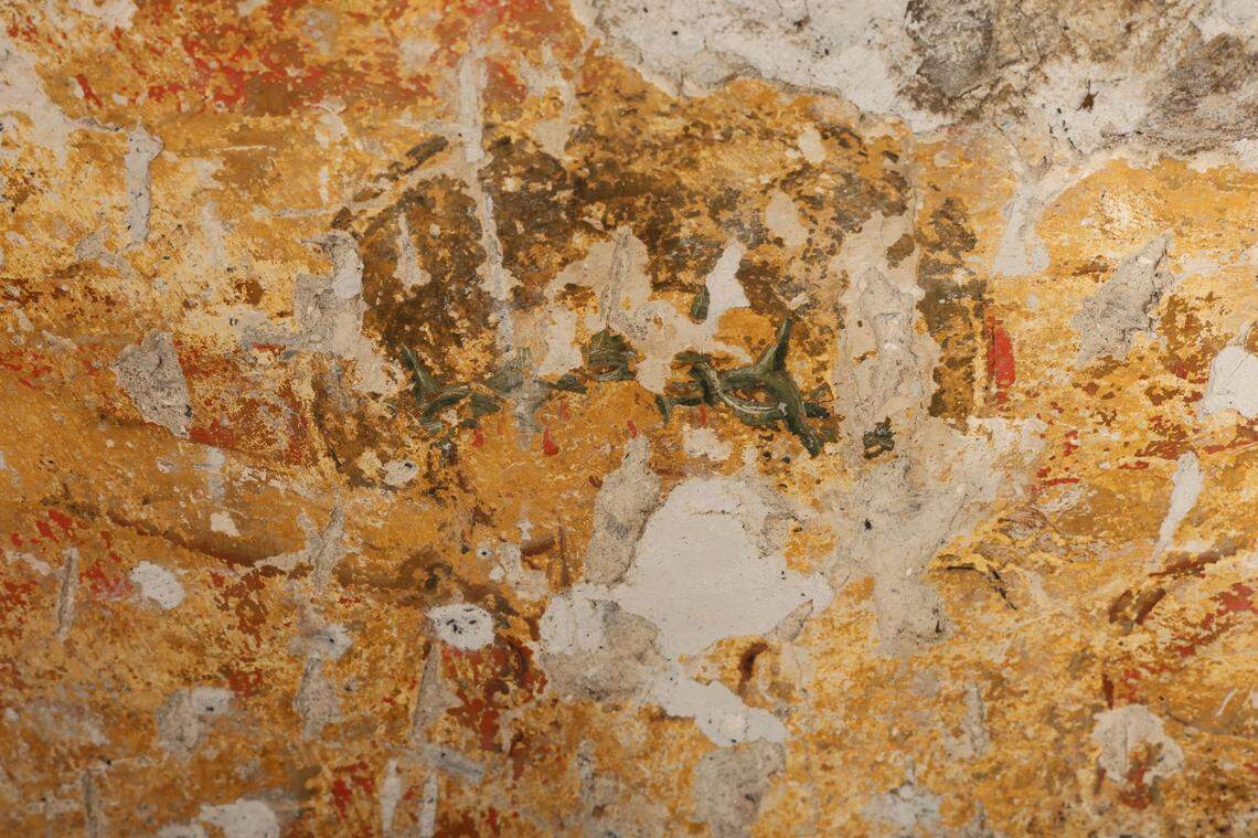 A crown of thorns from an image of Jesus on the cross stands out from the brightly-colored background.