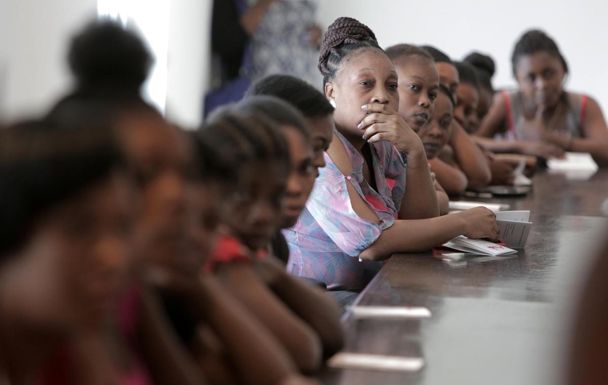 Female factory workers at Cleveland Manufacturing in Port-au-Prince, Haiti attend an informational session on how they can self-collect their own specimen as part of a cervical cancer screening program.