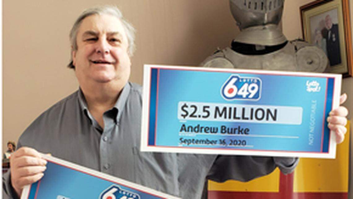 Andrew Burke, of Canada, with his winning lottery checks after accidentally buying two tickets with the same numbers he’s been playing for years.