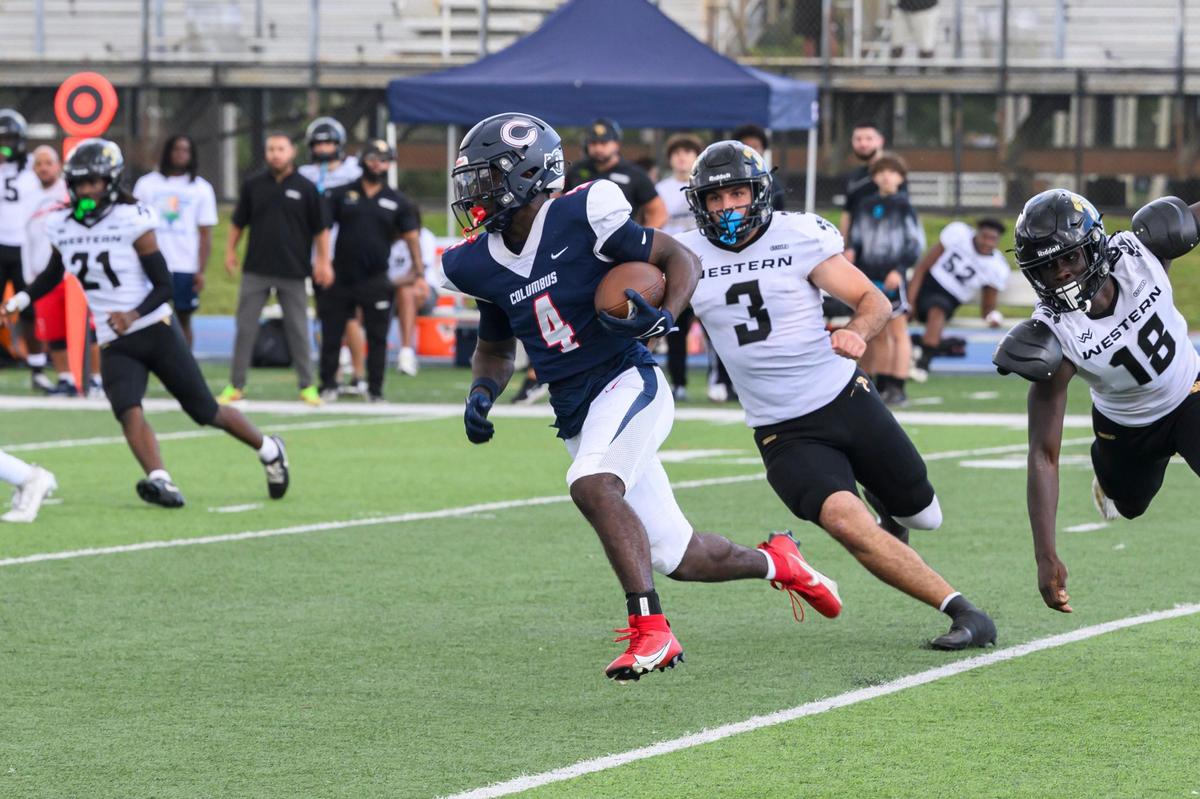 Columbus High School Safety Shaddai Carter (4) runs the ball during the game at Tropical Park on Friday, Nov. 29, 2024 in Miami, Fla.