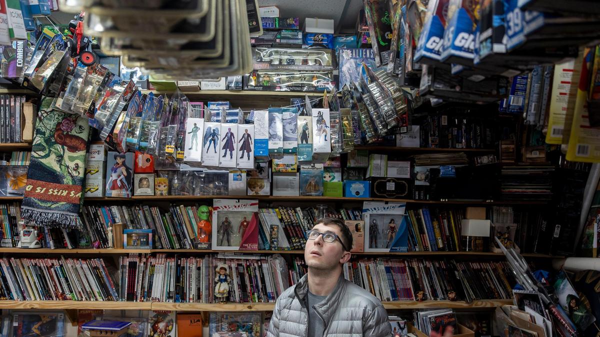 Customer Jake Berger, 27, shops at A&M Comics and Books on Friday, Jan. 24, 2025, in Miami.