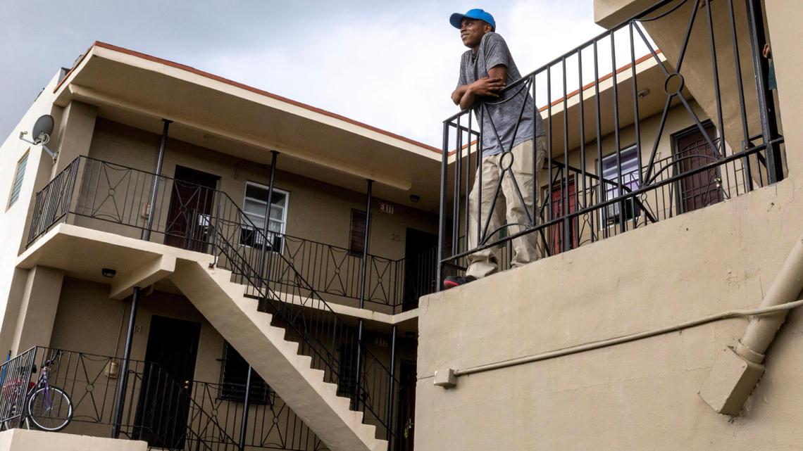 Jason Melus contemplates the future as he stands outside the Model City apartment where he lives with his father and sister in December 2022. Their rent increased and they were looking for an affordable place to live.