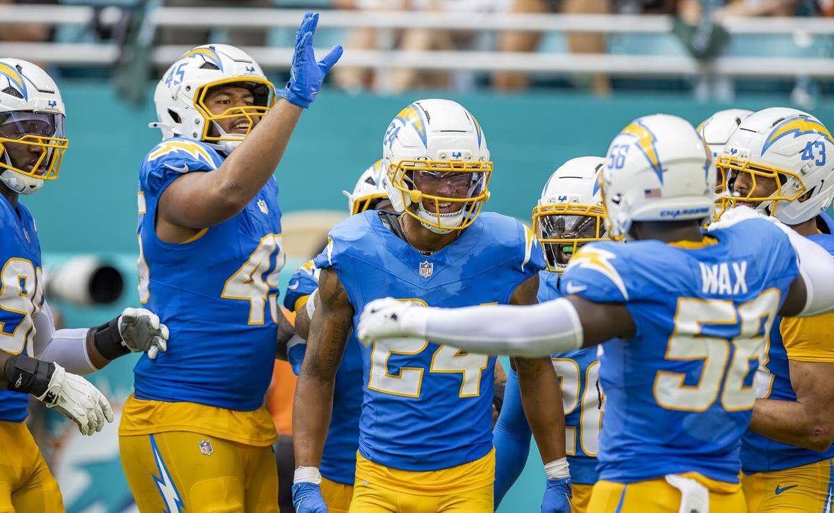 Los Angeles Chargers cornerback Benjamin St-Juste (24) celebrates with his teammates after intercepting a pass by Miami Dolphins quarterback Tua Tagovailoa (1) in the second half of their NFL game at Hard Rock Stadium on Sunday, Oct. 12, 2025, in Miami Gardens, Fla.