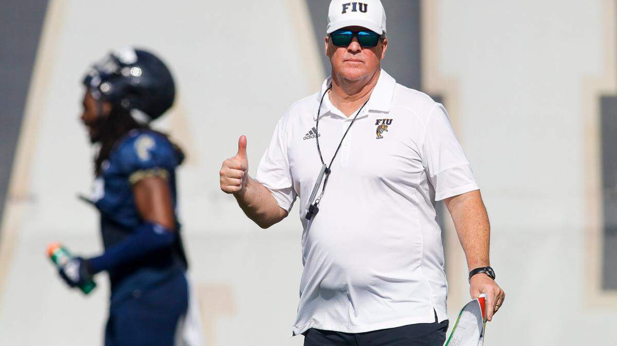 Florida International University head coach Mike MacIntyre gives a thumbs up from the field during football practice at the practice fields at Florida International University in Miami, Florida, on Thursday, March 24, 2022.