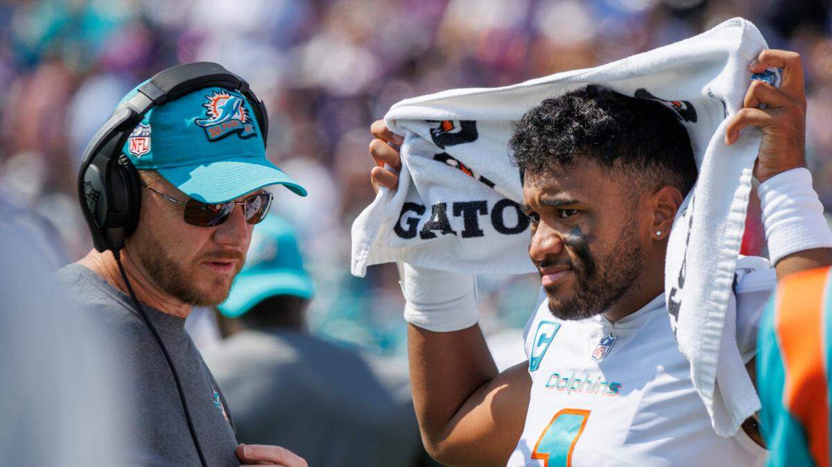 Miami Dolphins quarterbacks coach Darrell Bevell talks with quarterback Tua Tagovailoa (1) during second quarter of NFL football game against Baltimore Ravens at M&T Bank Stadium on Sunday, September 18, 2022 in Baltimore, MD.