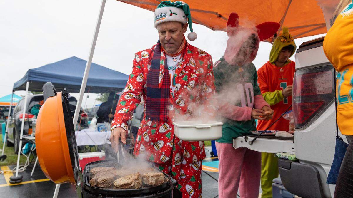 Miami Dolphins fans from Naples Erick Carter tailgating with his family before the start of an NFL game between the Miami Dolphins against the Green Bay Packers Hard Rock Stadium in Miami Gardens, Florida on Sunday, December 25, 2022.