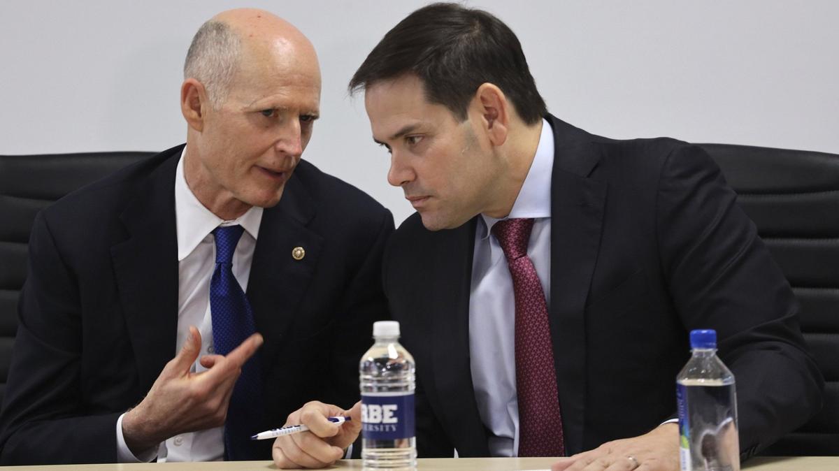 Florida Republican Sens. Rick Scott and Marco Rubio engage in conversation in November 2019 before speaking at a forum in Doral.