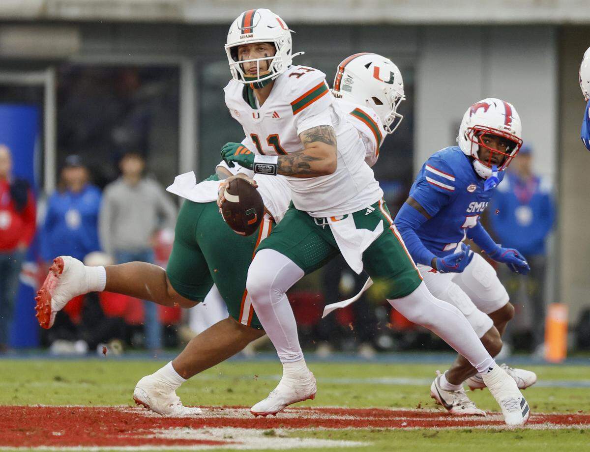 Miami Hurricanes quarterback Carson Beck (11) scrables out of the pocket during an NCAA football game against the Southern Methodist University Mustangs in the first half at Gerald Ford Stadium on Saturday, November 1, 2025, in Dallas, Texas.