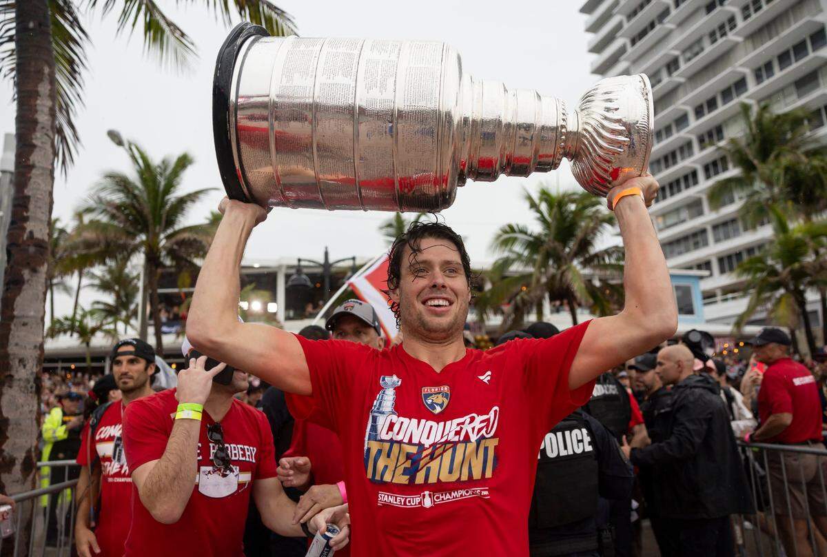 Florida Panthers center Carter Verhaeghe (23) lifts the Stanley Cup during a victory parade at the Fort Lauderdale Beach Park off A1A on Sunday, June 30, 2024, in Fort Lauderdale, Fla. The parade was held to celebrate the Florida Panthers after they defeated the Edmonton Oilers in Game 7 of the Stanley Cup Final.