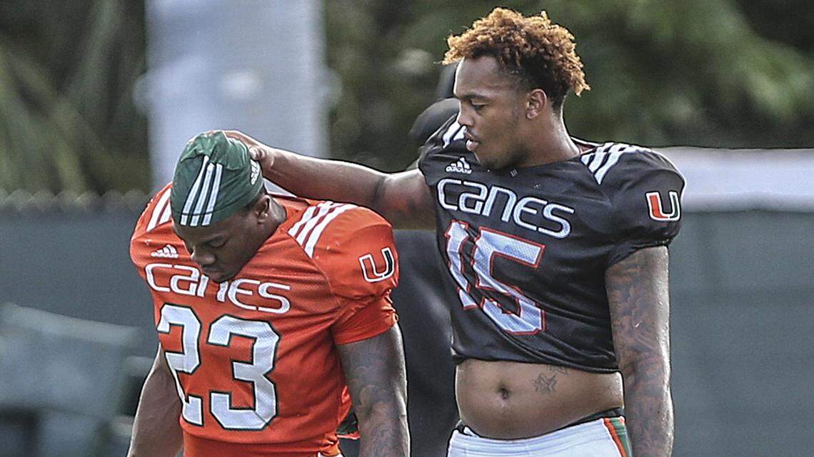 University of Miami freshman running back Cam’Ron Davis (23) gets a tap on the head from freshman quarterback Jarren Williams at practice on Monday, August 13, 2018.