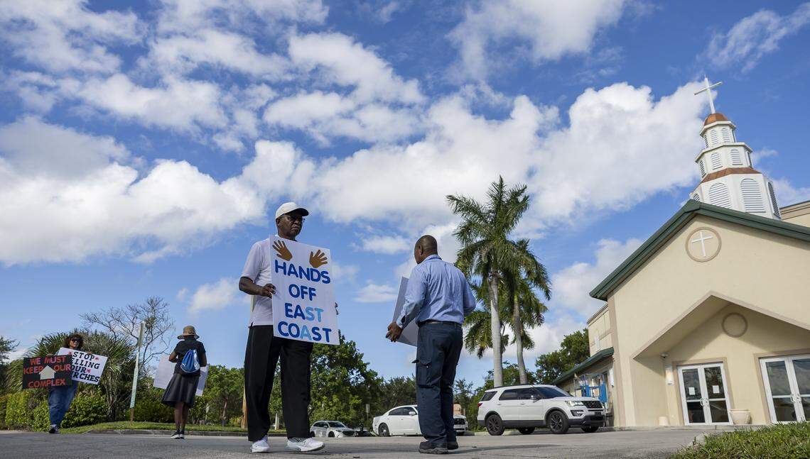 Gino Jamison holds a sign as he gathers with fellow activists to protest outside the House of God Church, Keith Dominion, on Friday, Sept. 19, 2025, in Pompano Beach, Fla. Members of South Florida congregations organized the protest after learning that longtime churches were being sold for what they say is below market value.