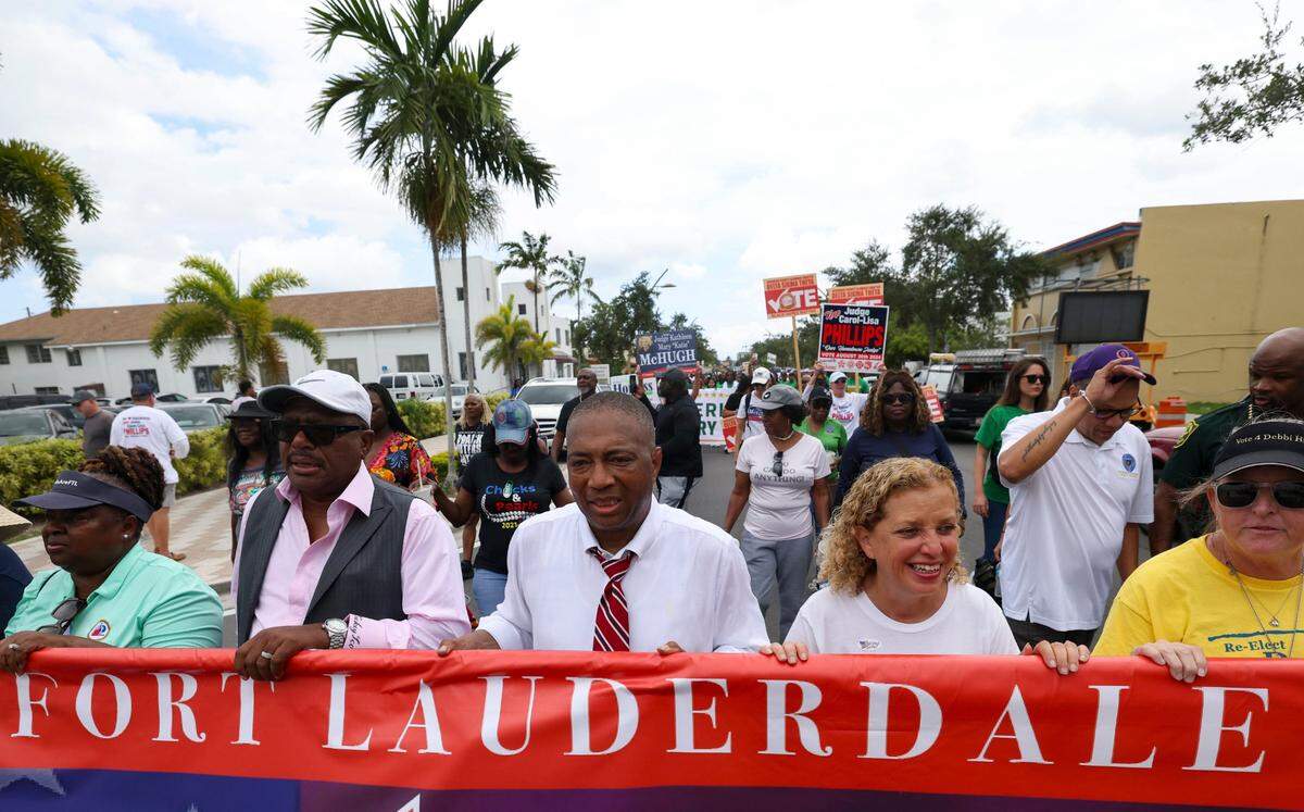 Senator Chris Smith, center, Congresswoman Debbie Wasserman Schultz, to the right, and other local leaders march during the Souls to the Polls march to the African American Research Library and Cultural Center on Sunday, Aug. 18, 2024, in Fort Lauderdale, Fla.