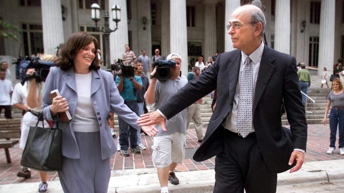 Stanley Rosenblatt helps his wife, Susan, cross Flagler Street as they leave the courthouse after the big tobacco verdict on July 14, 2000.